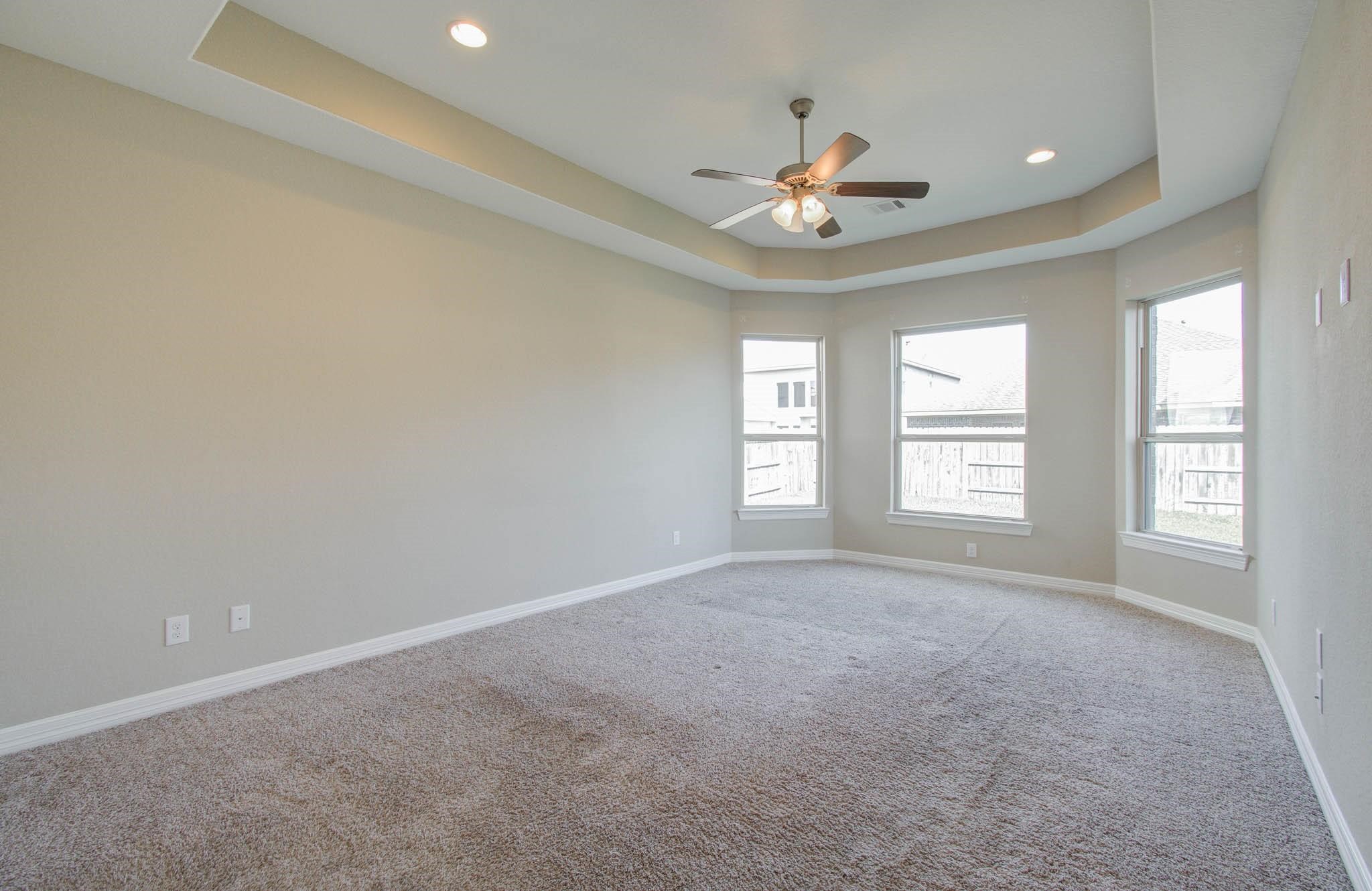 27911 Seger Bnd Trail Spring, TX 77386 - Photo 27 of 49 en empty room with windows and chandelier fan