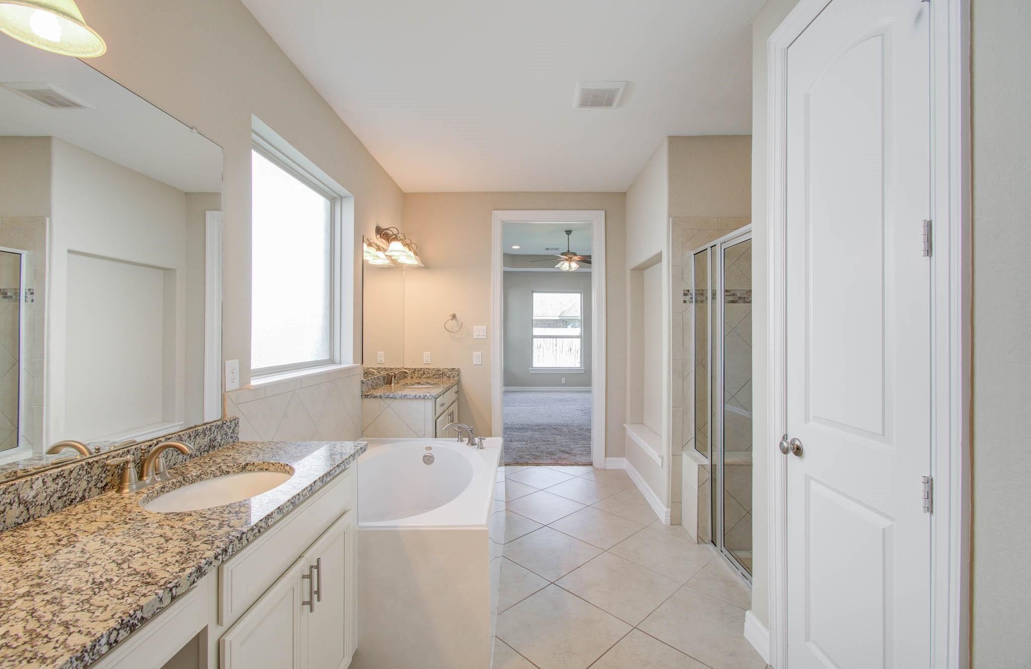 27911 Seger Bnd Trail Spring, TX 77386 - Photo 32 of 49 a bathroom with a granite countertop sink and a mirror