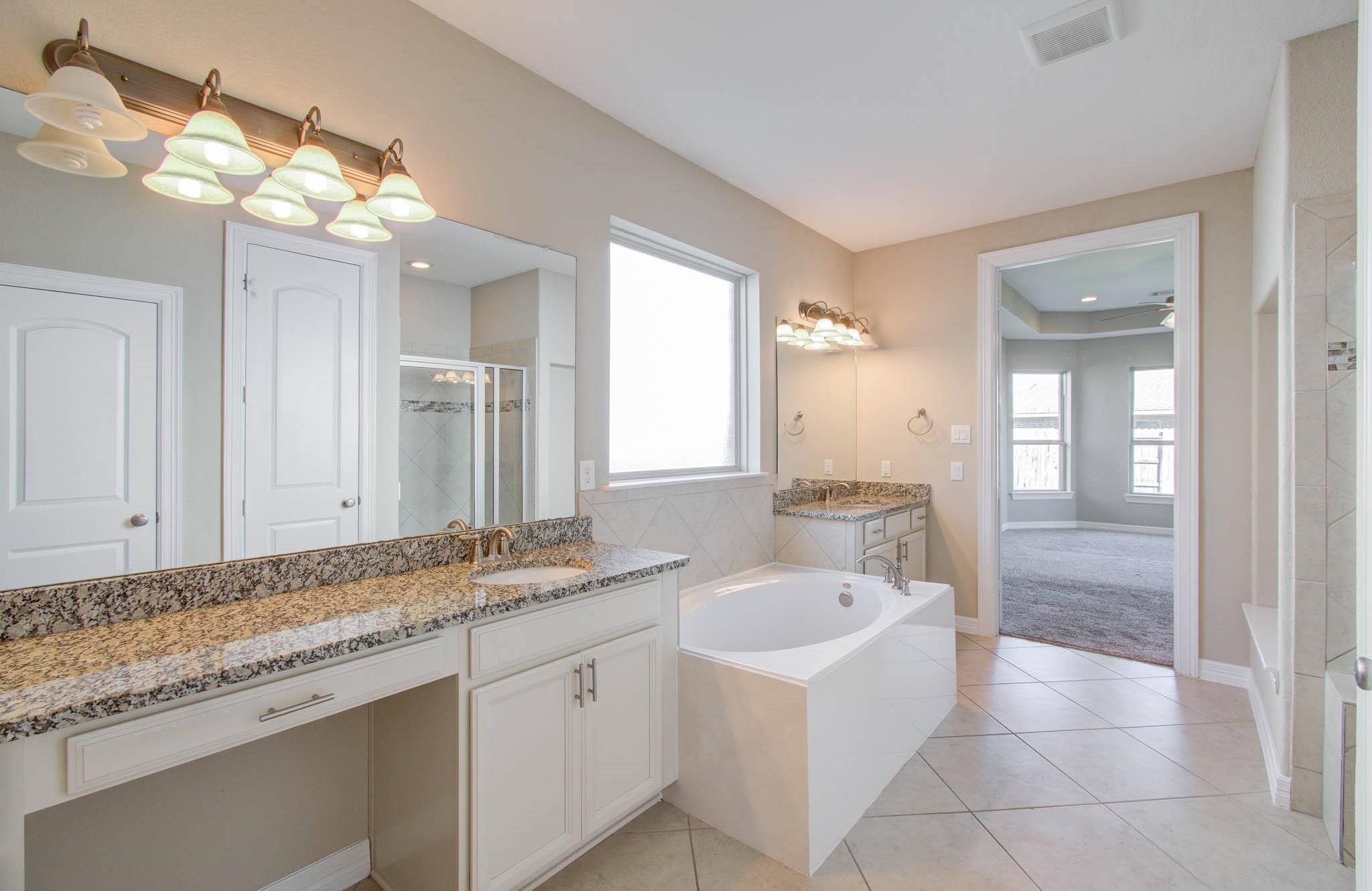 27911 Seger Bnd Trail Spring, TX 77386 - Photo 34 of 49 a bathroom with a granite countertop sink and a mirror