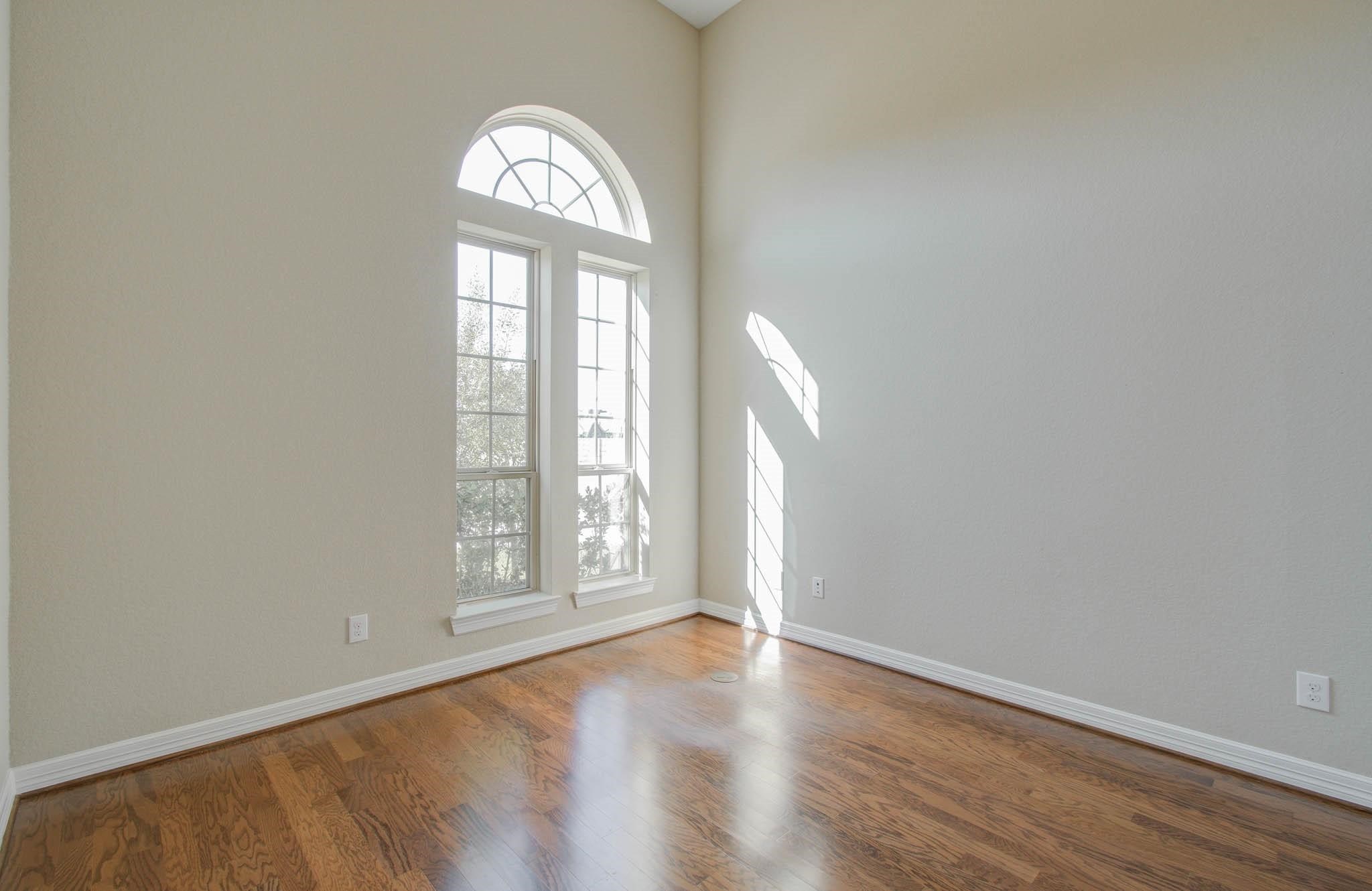 27911 Seger Bnd Trail Spring, TX 77386 - Photo 5 of 49 an empty room with wooden floor and windows