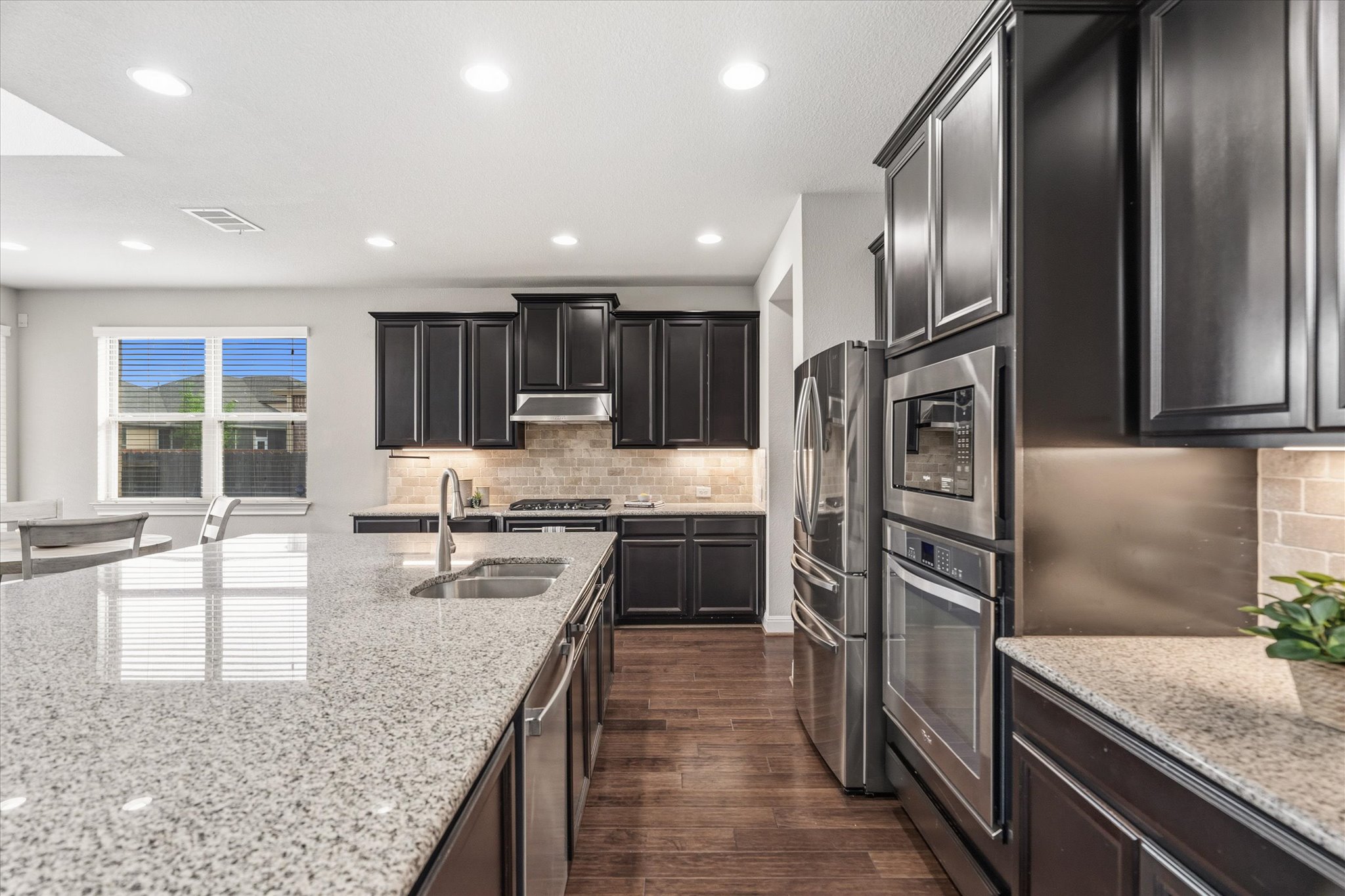 2300 Centennial Loop Round Rock, TX 78665 - Photo 11 of 40 Stainless appliances and granite countertops enhance the kitchen’s polished design.