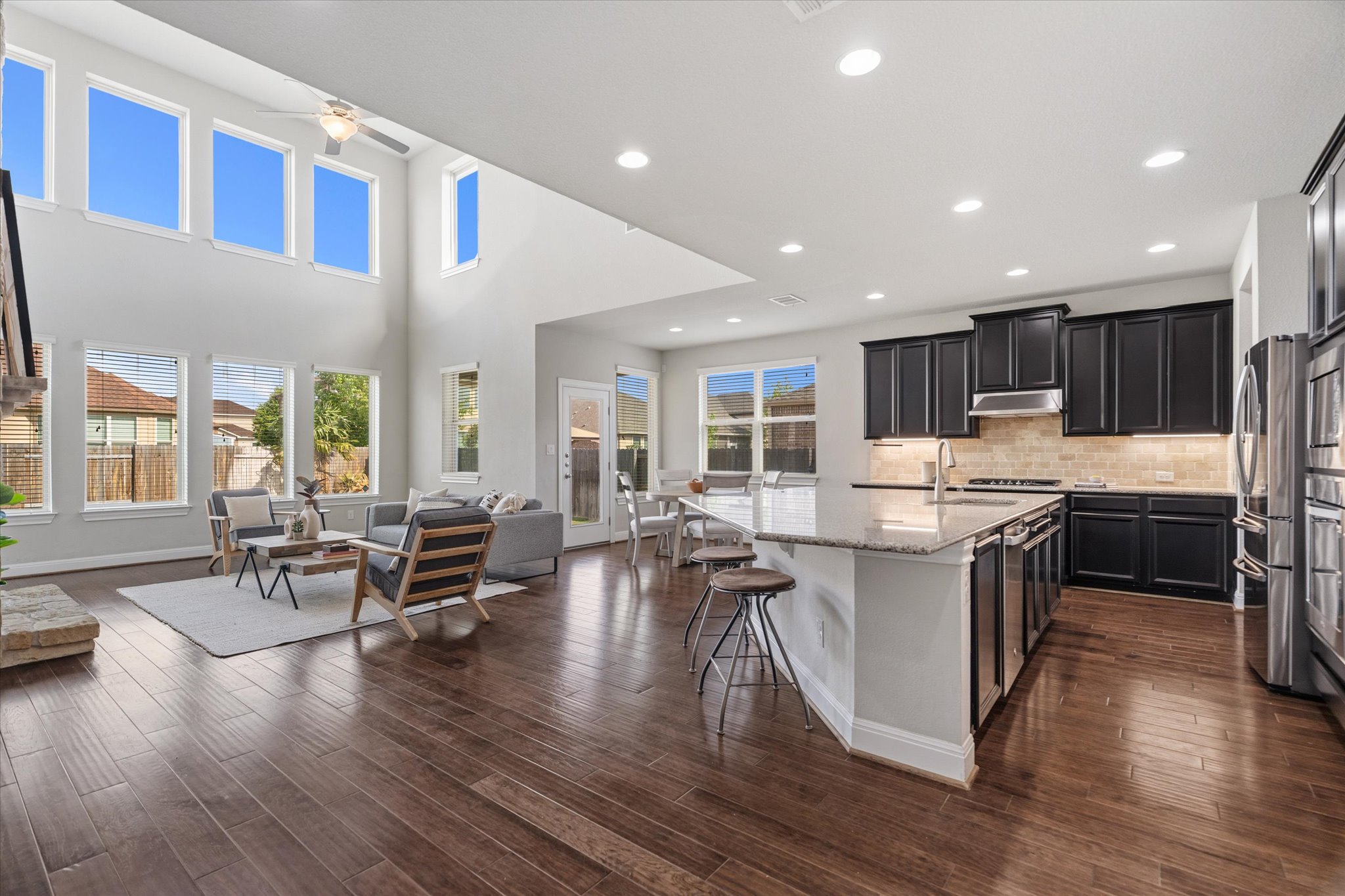 2300 Centennial Loop Round Rock, TX 78665 - Photo 4 of 40 The spacious great room features soaring ceilings and expansive windows that fill the space with natural light.