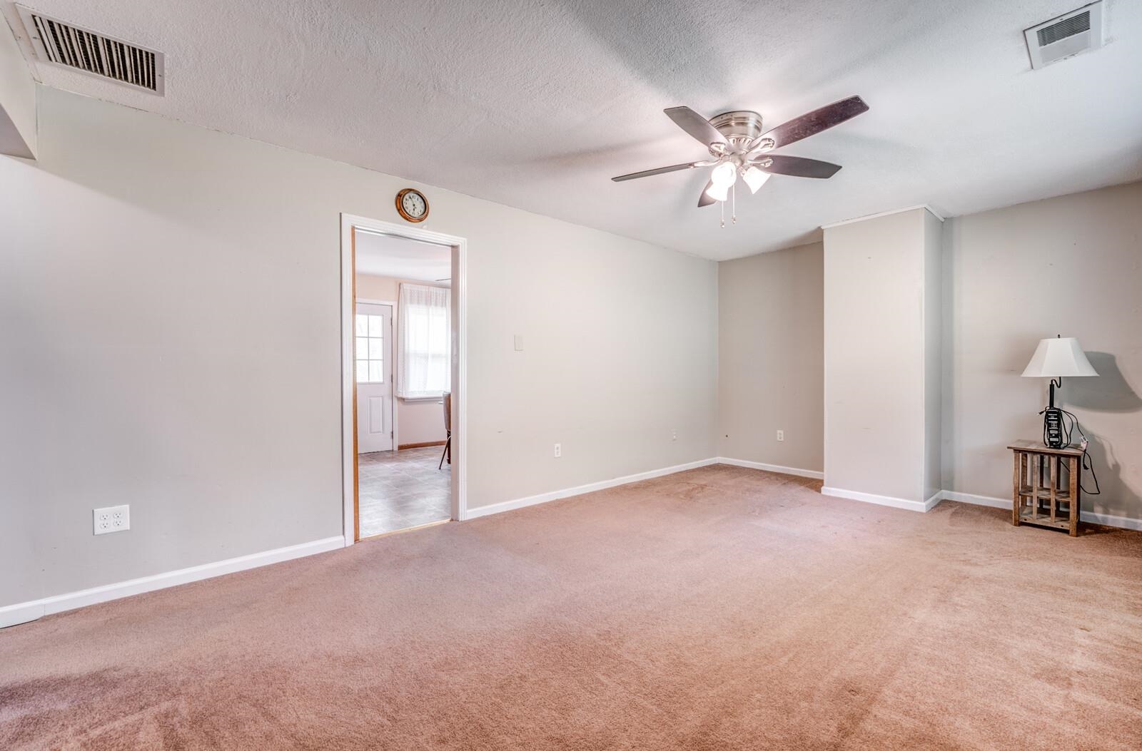 6125 Warren Road Oakland, TN 38060 - Photo 7 of 40 Carpeted room featuring a ceiling fan with integrated lighting, neutral wall paint, and white trim