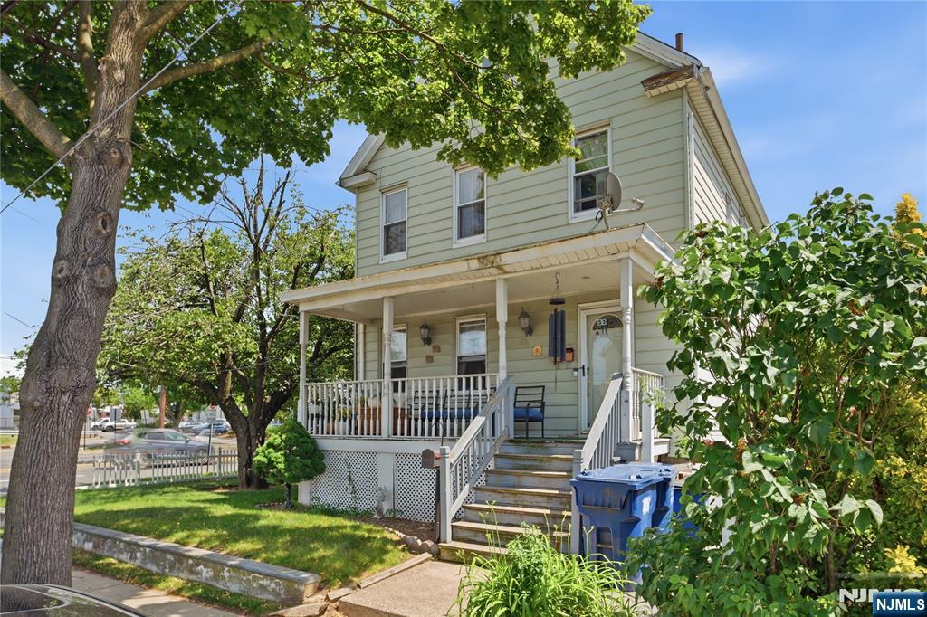 33-35 Pulaski Place Hackensack, NJ 07601 - Photo 5 of 32 front view of a house with a yard