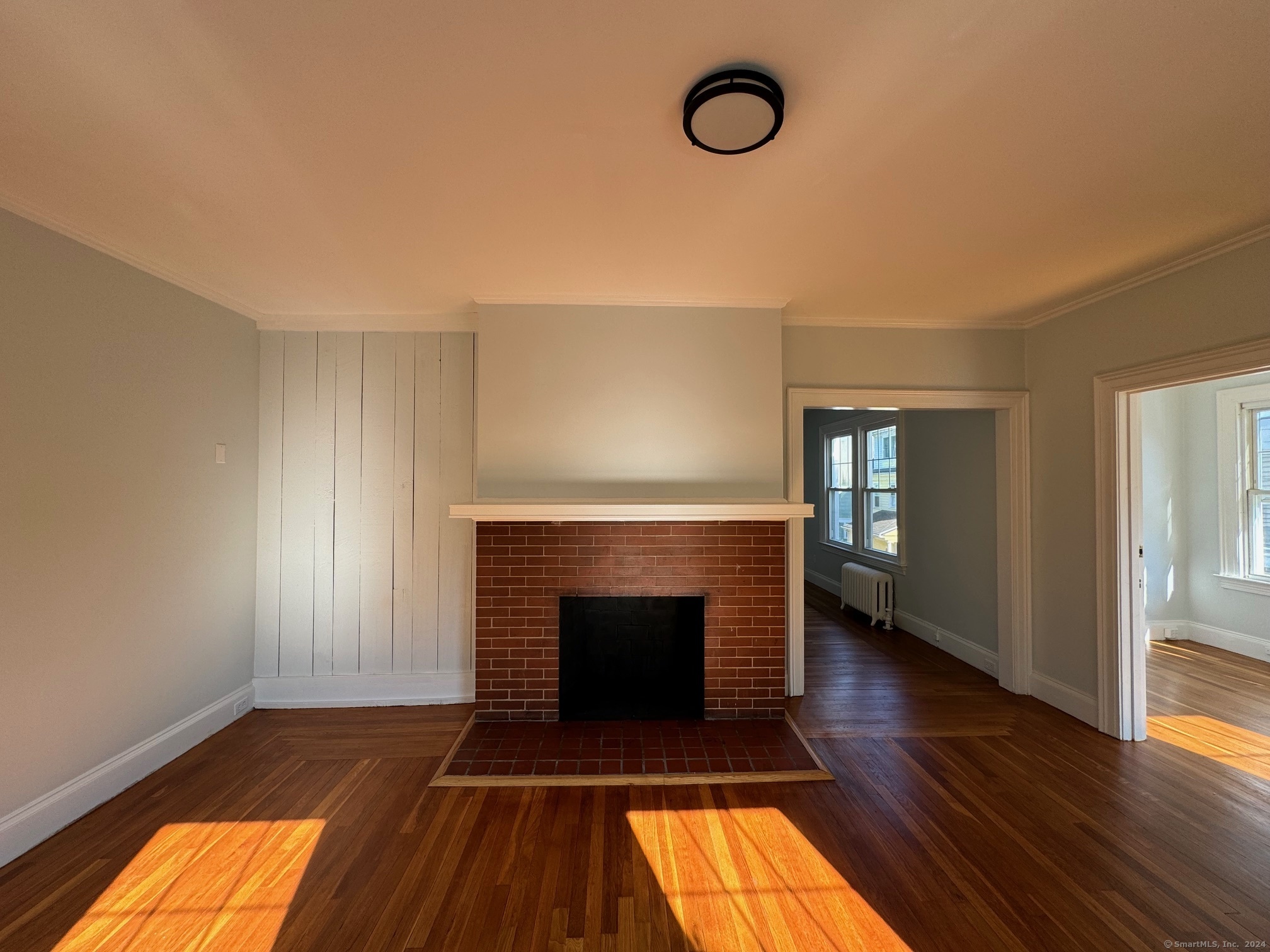 1253 Forest Road, Unit 2 New Haven, CT 06515 - Photo 14 of 30 a living room with a fireplace and wooden floor
