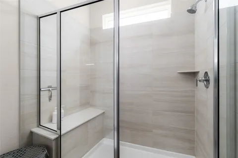 a bathroom with a glass shower door