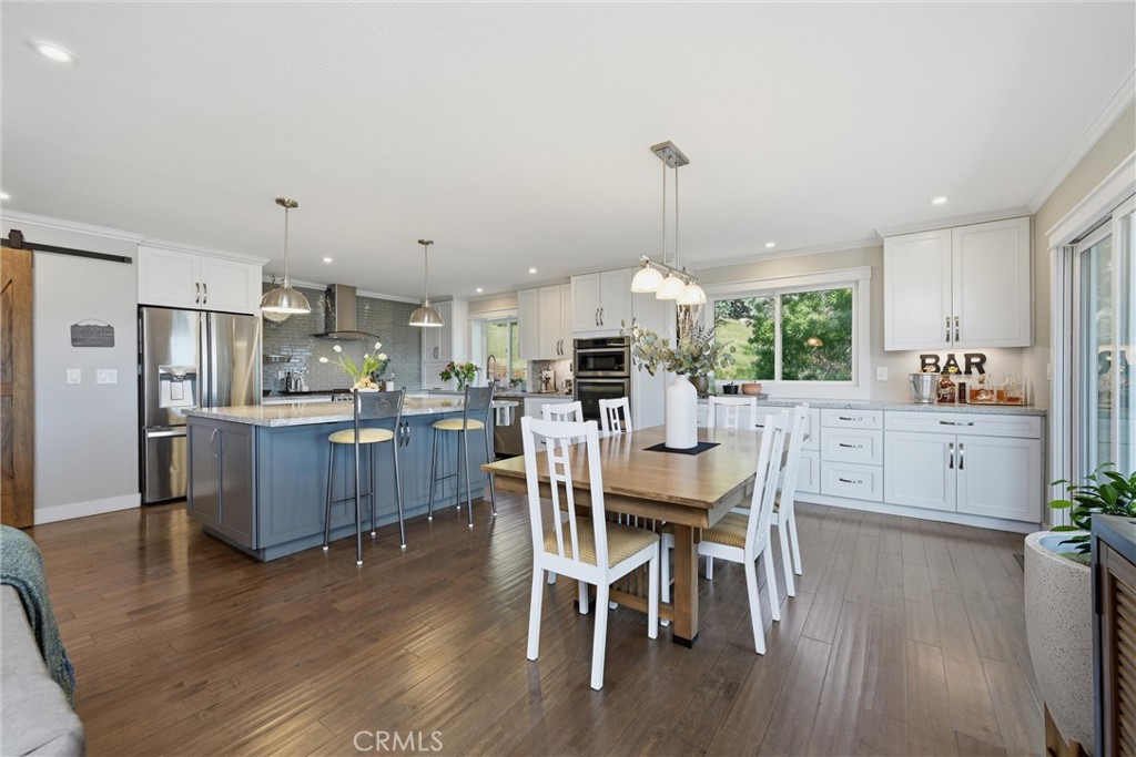 17432 Greenridge Road Hidden Valley Lake, CA 95467 - Photo 17 of 72 a kitchen with stainless steel appliances kitchen island wooden floors and white cabinets