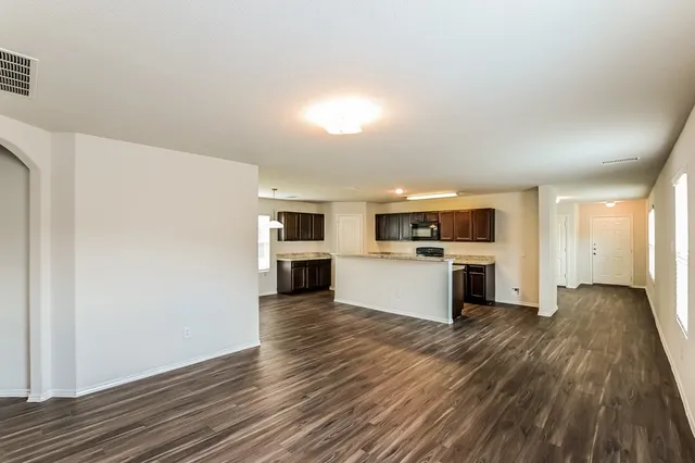 a view of kitchen with microwave and cabinets