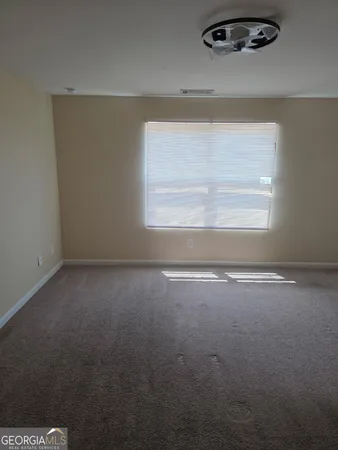 an empty room with a empty space and windows