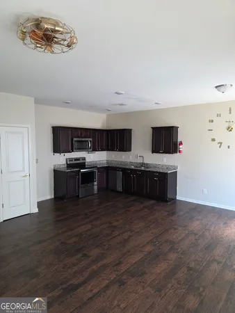 a view of kitchen with microwave and cabinets