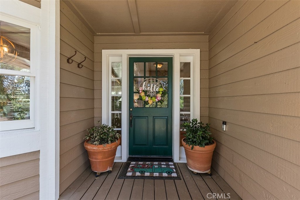 35455 El Niguel Road Lake Elsinore, CA 92530 - Photo 19 of 58 a potted plant sitting in front of a house with potted plants