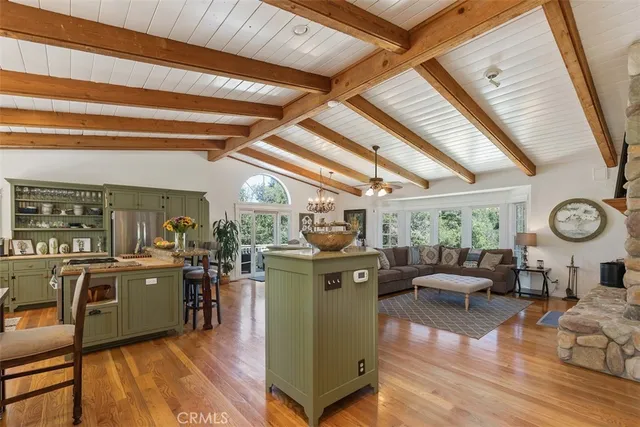 a living room with furniture a fireplace and a large window
