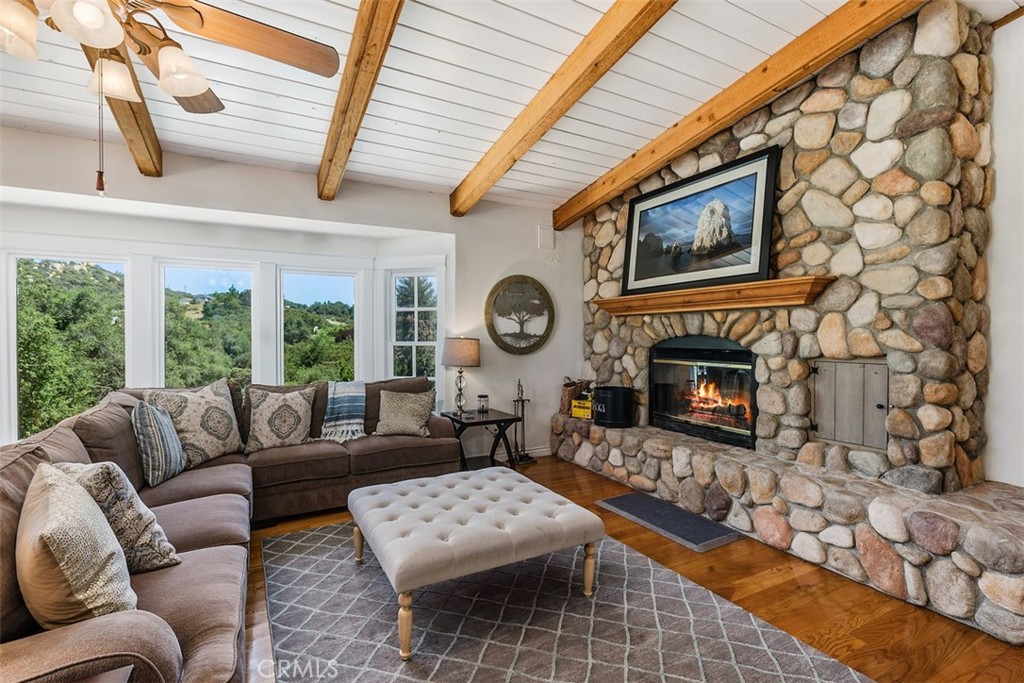 35455 El Niguel Road Lake Elsinore, CA 92530 - Photo 23 of 58 a living room with furniture a fireplace and a large window