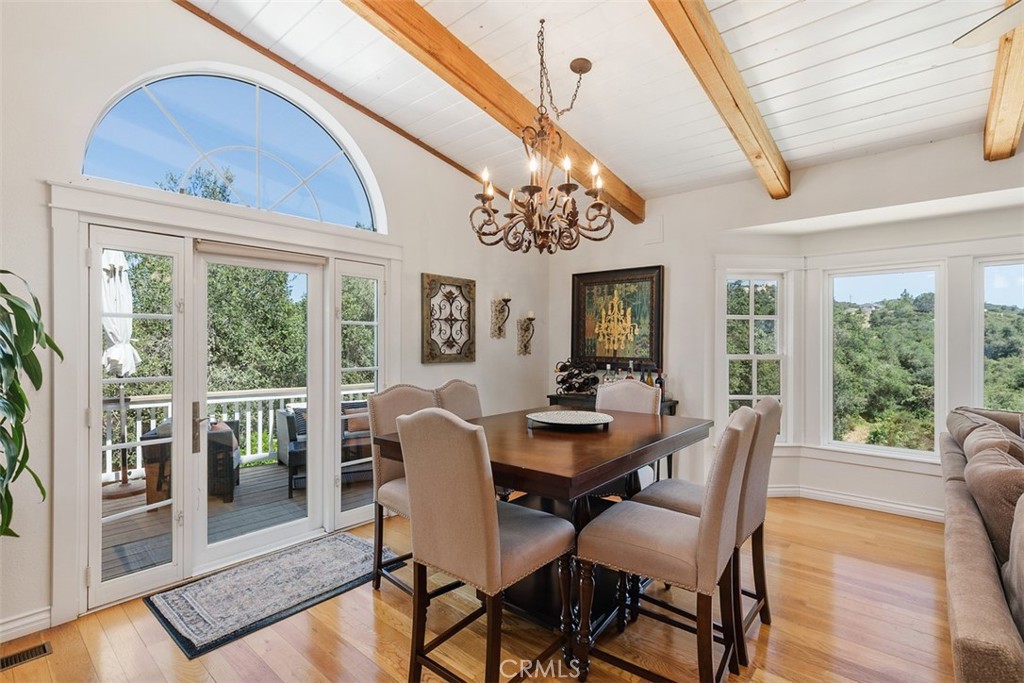 35455 El Niguel Road Lake Elsinore, CA 92530 - Photo 25 of 58 a view of a dining room with furniture large windows and wooden floor