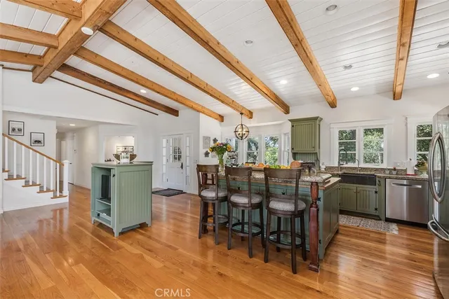 a kitchen with a stove and a dining table