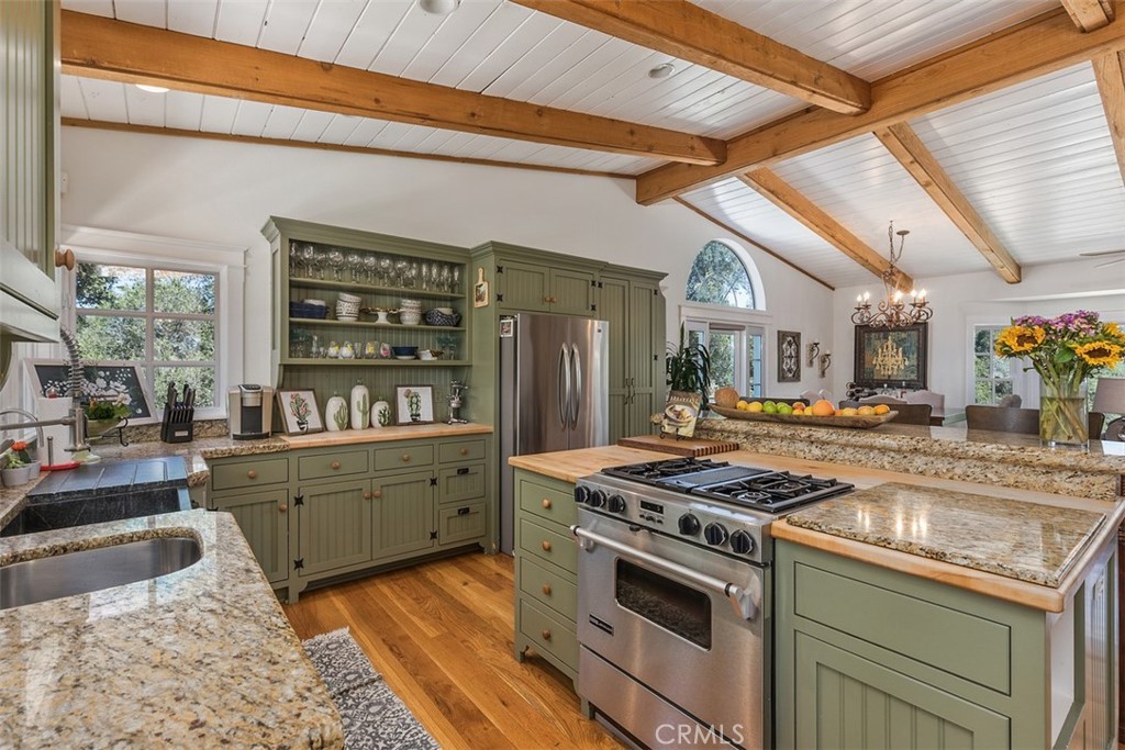 35455 El Niguel Road Lake Elsinore, CA 92530 - Photo 28 of 58 a kitchen with granite countertop a stove and cabinets
