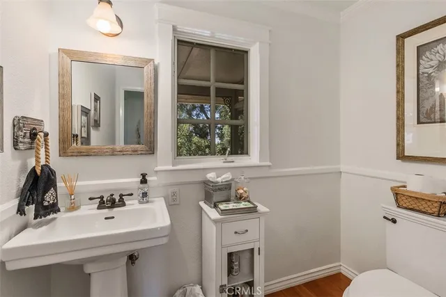 a living room with furniture a dining table and a refrigerator