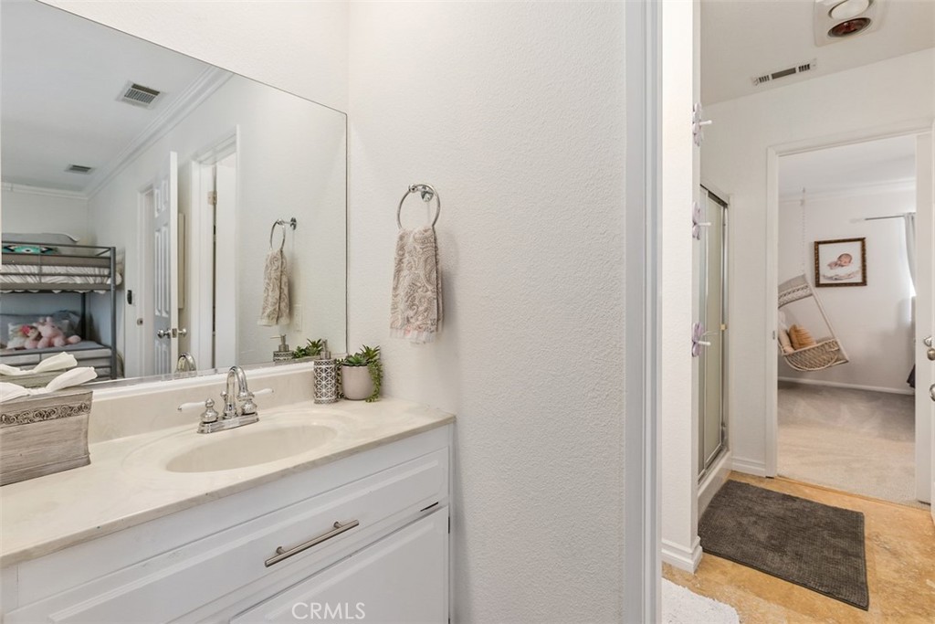35455 El Niguel Road Lake Elsinore, CA 92530 - Photo 40 of 58 a en suite bathroom with a sink and a mirror