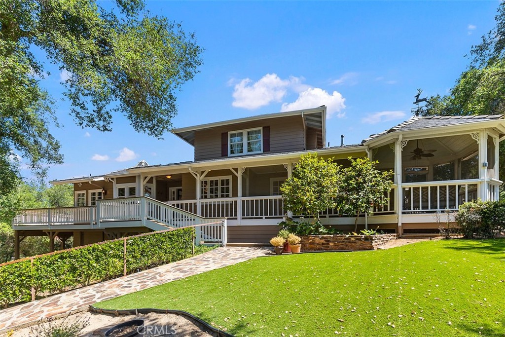 35455 El Niguel Road Lake Elsinore, CA 92530 - Photo 4 of 58 a front view of a house with a yard table and chairs