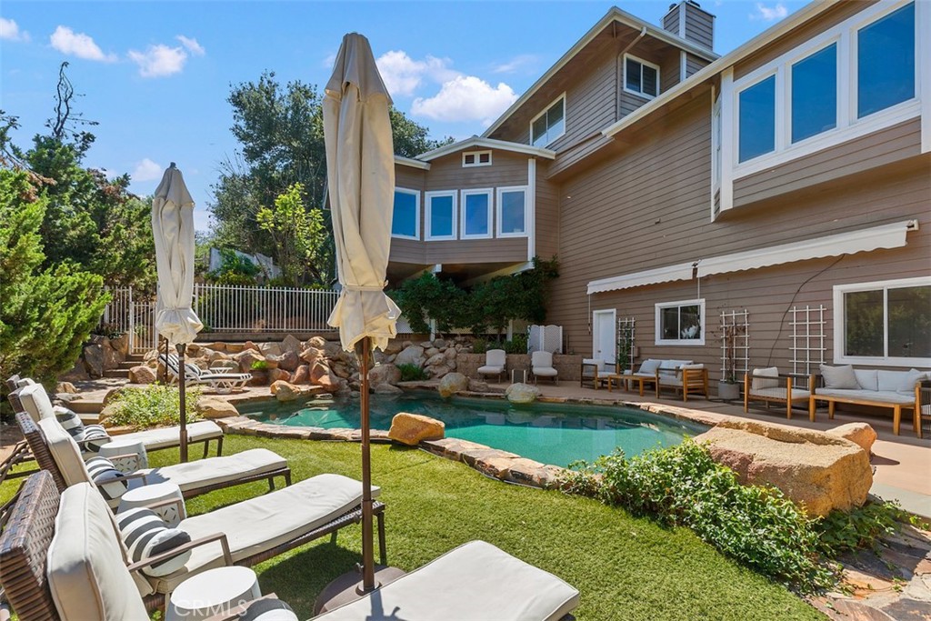 35455 El Niguel Road Lake Elsinore, CA 92530 - Photo 47 of 58 a front view of a house with swimming pool garden and patio