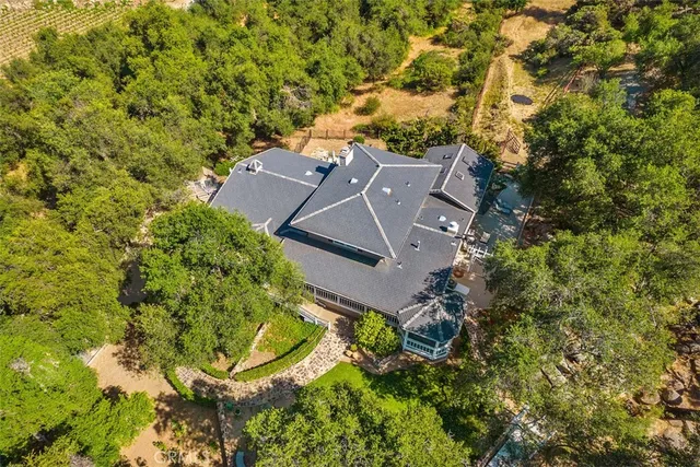 an aerial view of a house with a yard