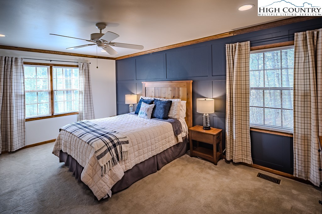 281 Old Hartley Road Banner Elk, NC 28604 - Photo 24 of 50 a bedroom with a bed and a chandelier