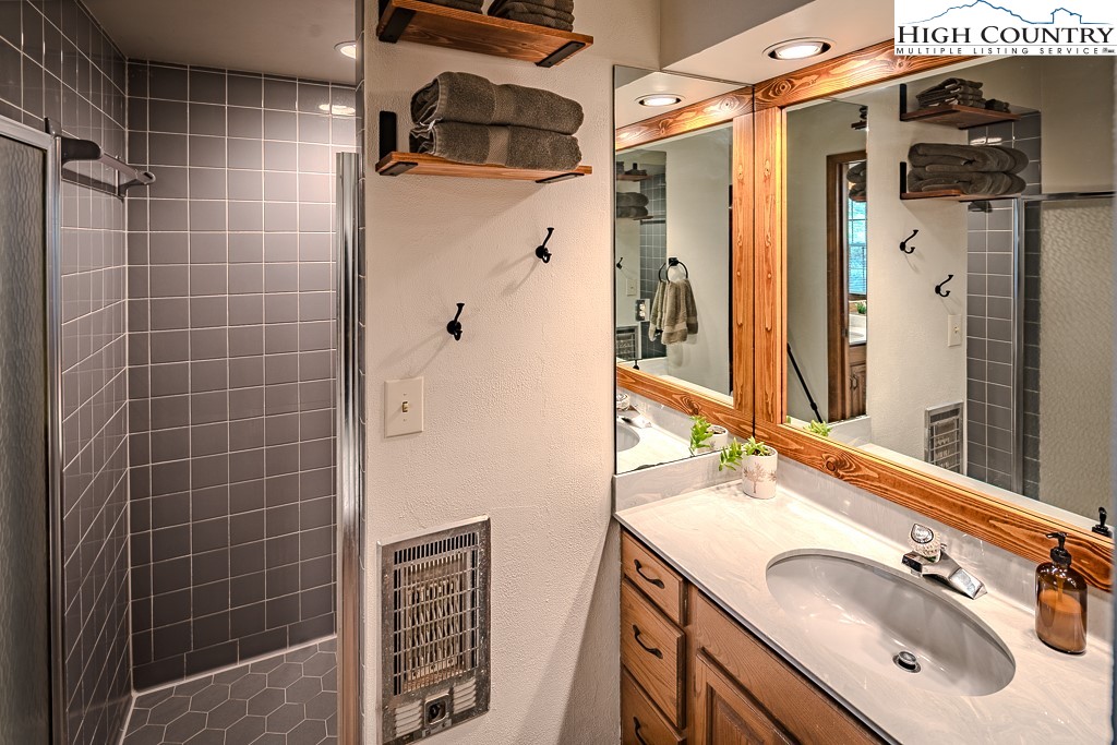281 Old Hartley Road Banner Elk, NC 28604 - Photo 26 of 50 a bathroom with a sink vanity and a mirror