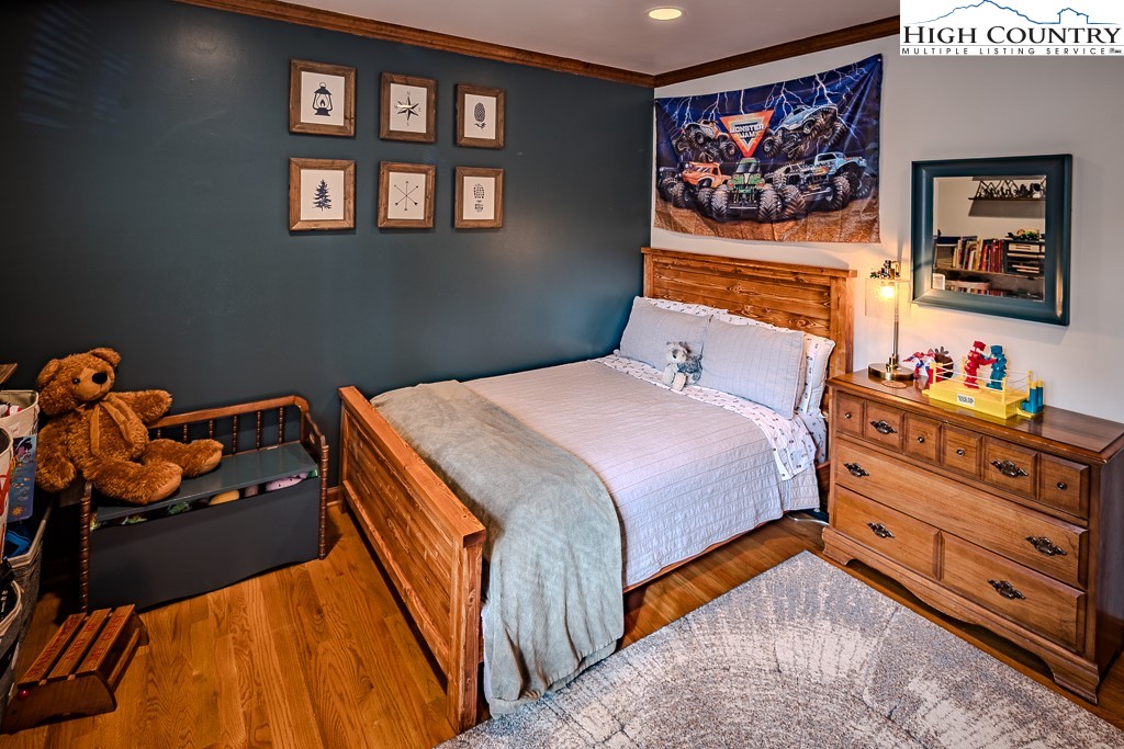 281 Old Hartley Road Banner Elk, NC 28604 - Photo 29 of 50 a bedroom with a bed and dresser in it