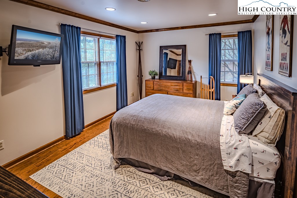 281 Old Hartley Road Banner Elk, NC 28604 - Photo 32 of 50 a bed sitting in a bedroom next to a window