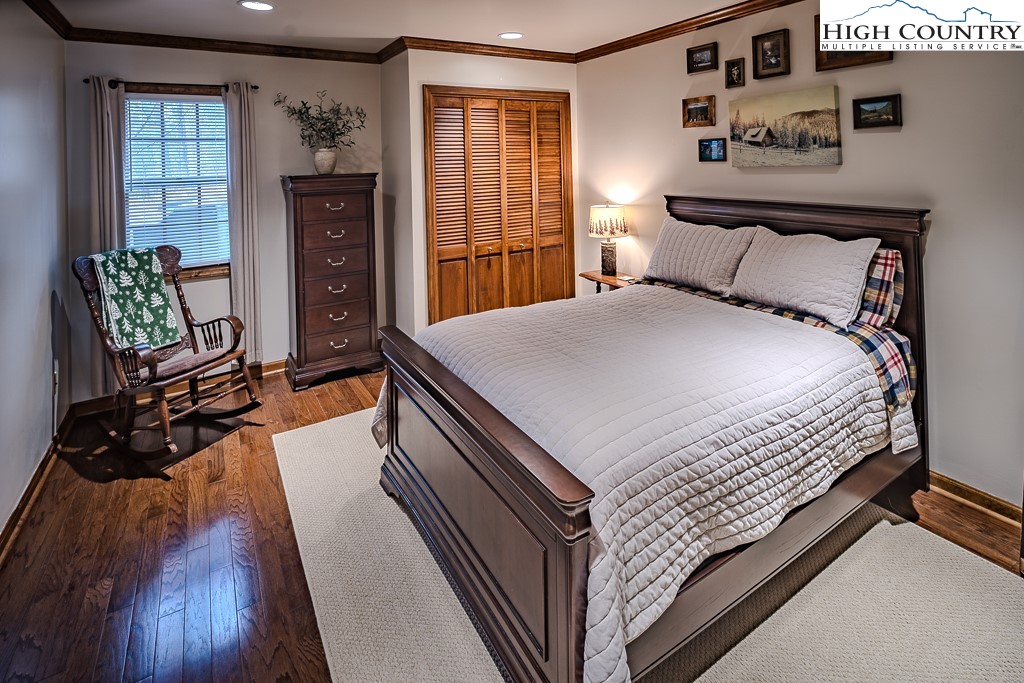 281 Old Hartley Road Banner Elk, NC 28604 - Photo 35 of 50 a bedroom with a bed and wooden floor