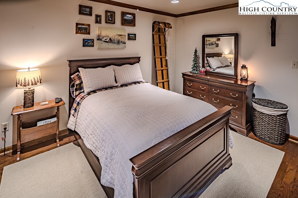 281 Old Hartley Road Banner Elk, NC 28604 - Photo 36 of 50 a bedroom with a bed and dresser with chair