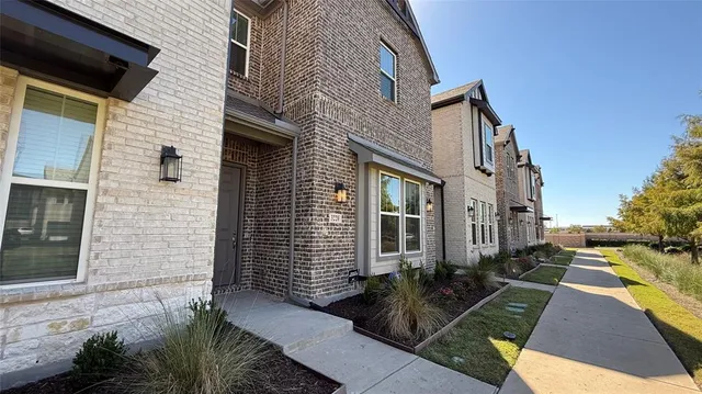a view of a brick house with many windows