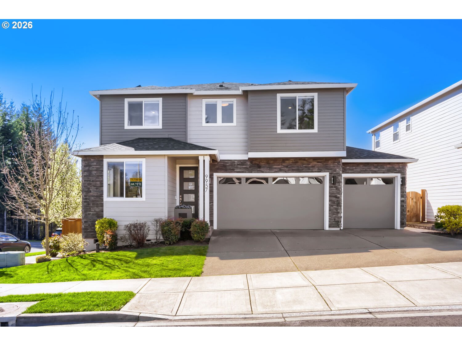 a front view of a house with a garden