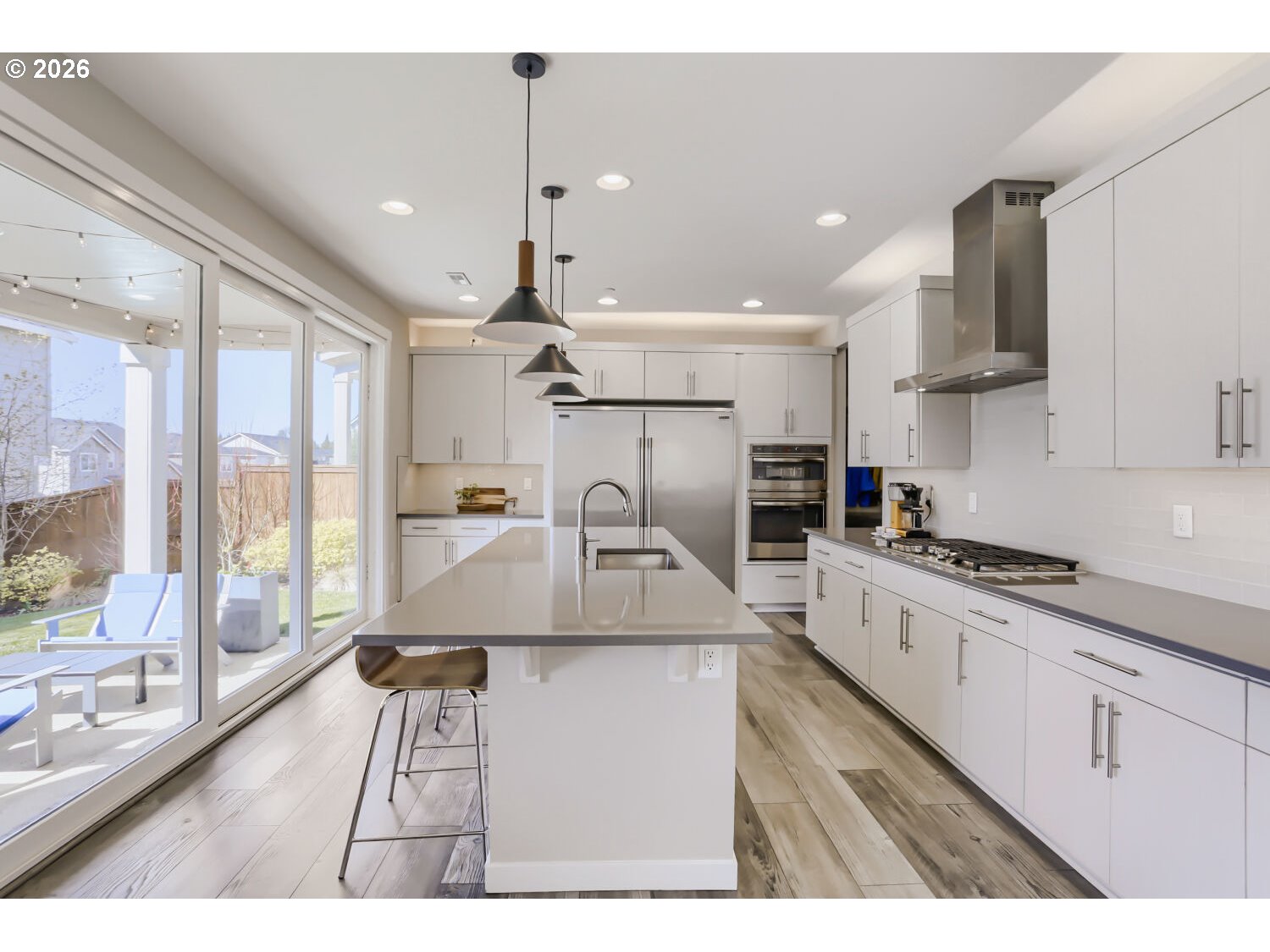 9957 Southwest 173rd Avenue Beaverton, OR 97007 - Photo 14 of 45 a large kitchen with stainless steel appliances kitchen island granite countertop a sink and cabinets