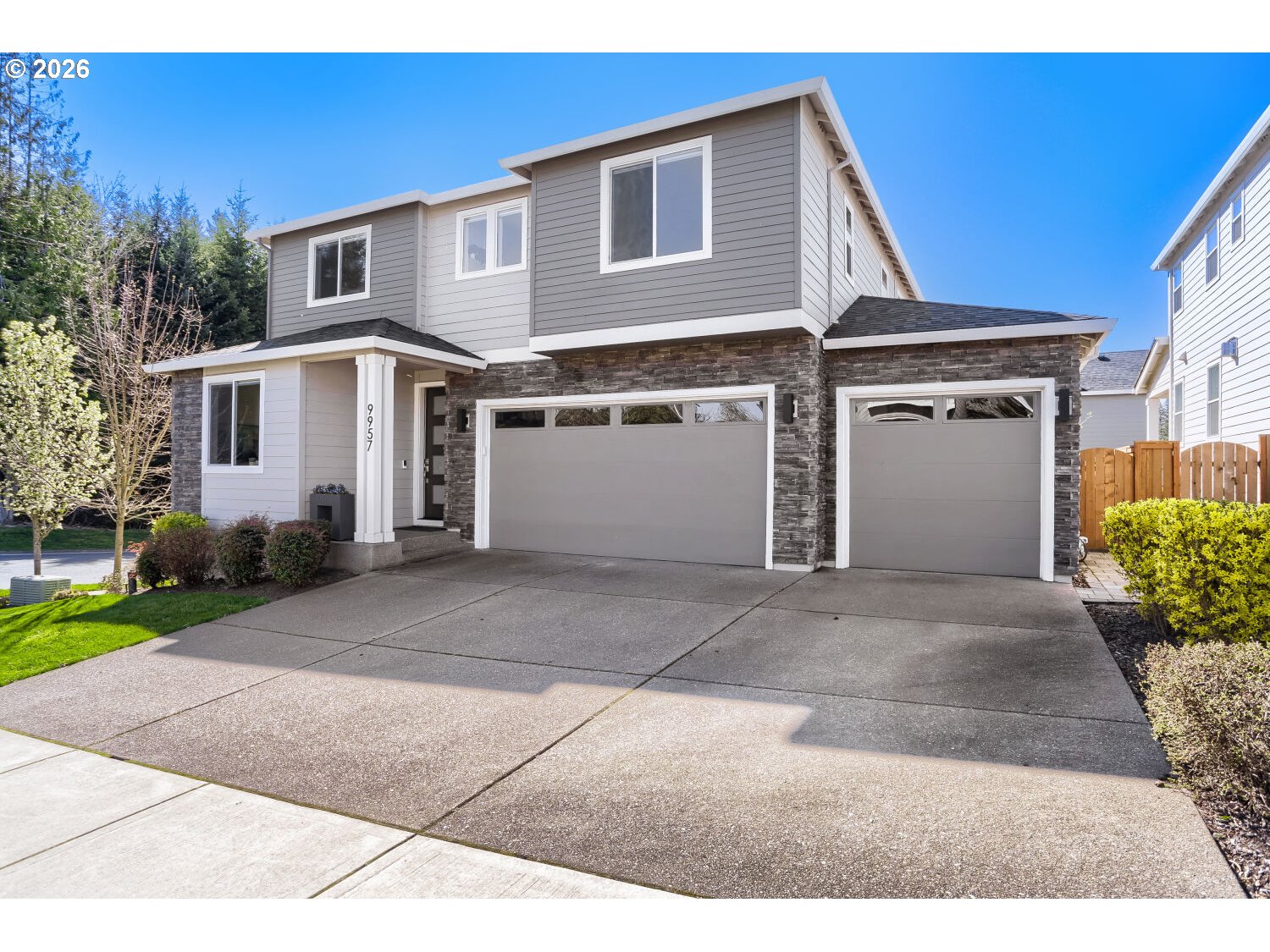 9957 Southwest 173rd Avenue Beaverton, OR 97007 - Photo 2 of 45 a front view of a house with a yard and garage