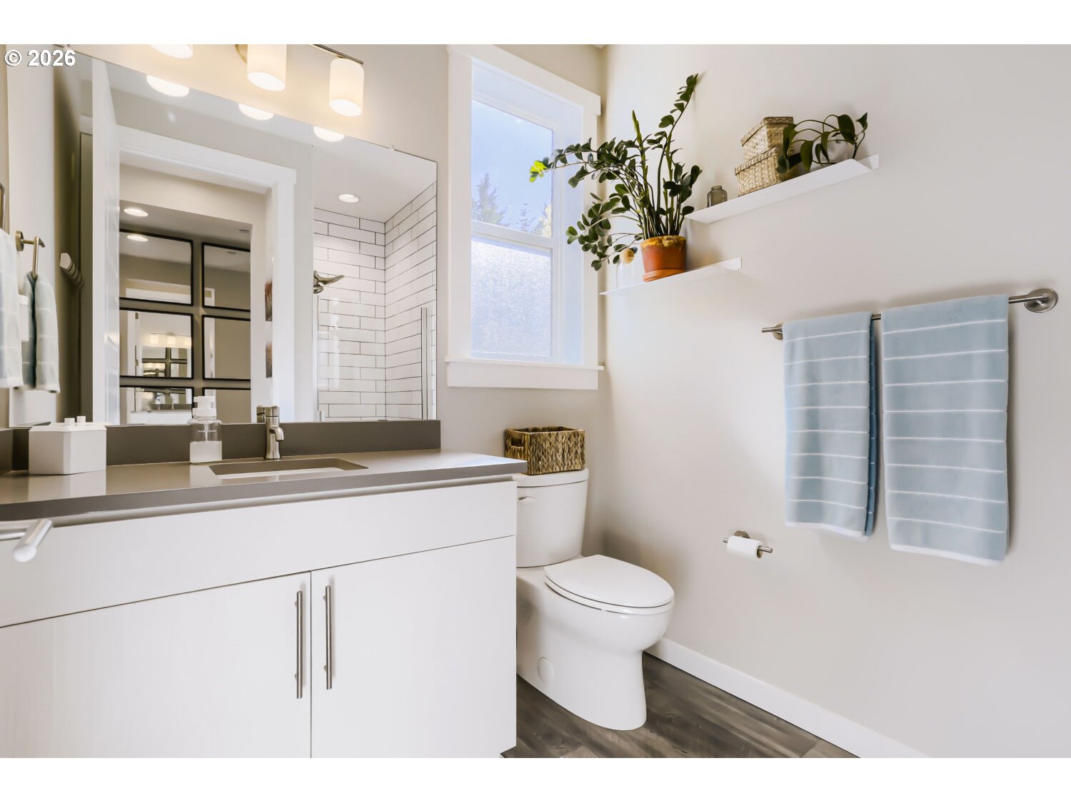 9957 Southwest 173rd Avenue Beaverton, OR 97007 - Photo 21 of 45 a bathroom with a sink a toilet and a mirror