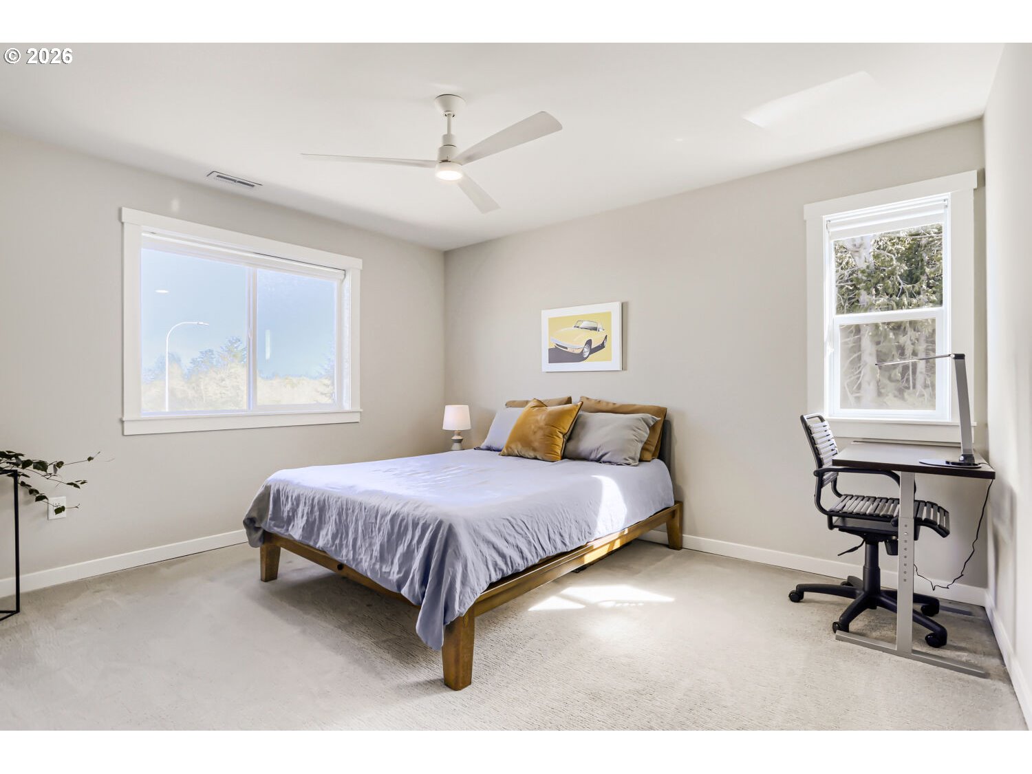 9957 Southwest 173rd Avenue Beaverton, OR 97007 - Photo 34 of 45 a spacious bedroom with a bed a table and a window