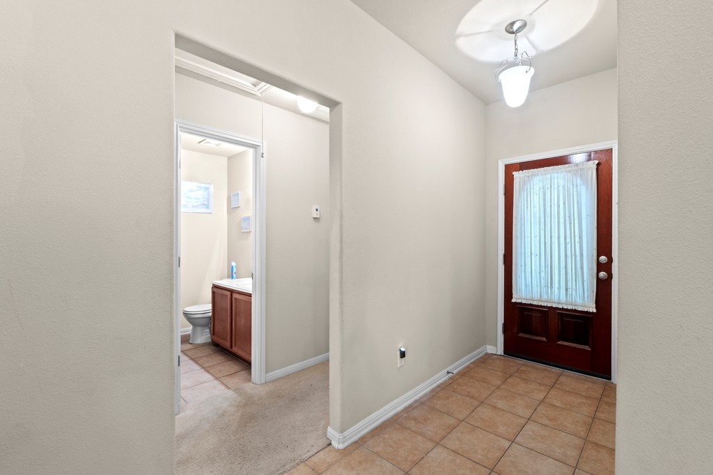 12008 Lansdowne Road Austin, TX 78754 - Photo 20 of 29 A welcoming front entry features durable tile flooring, providing a practical and attractive transition into the home.