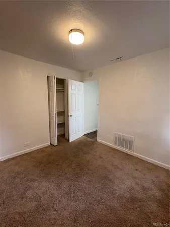 a view of an empty room with a closet
