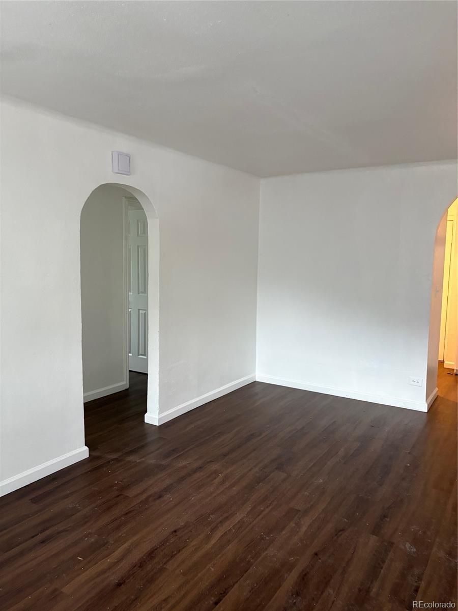 1565 Xanthia Street Denver, CO 80220 - Photo 4 of 7 a view of an empty room with wooden floor and a window