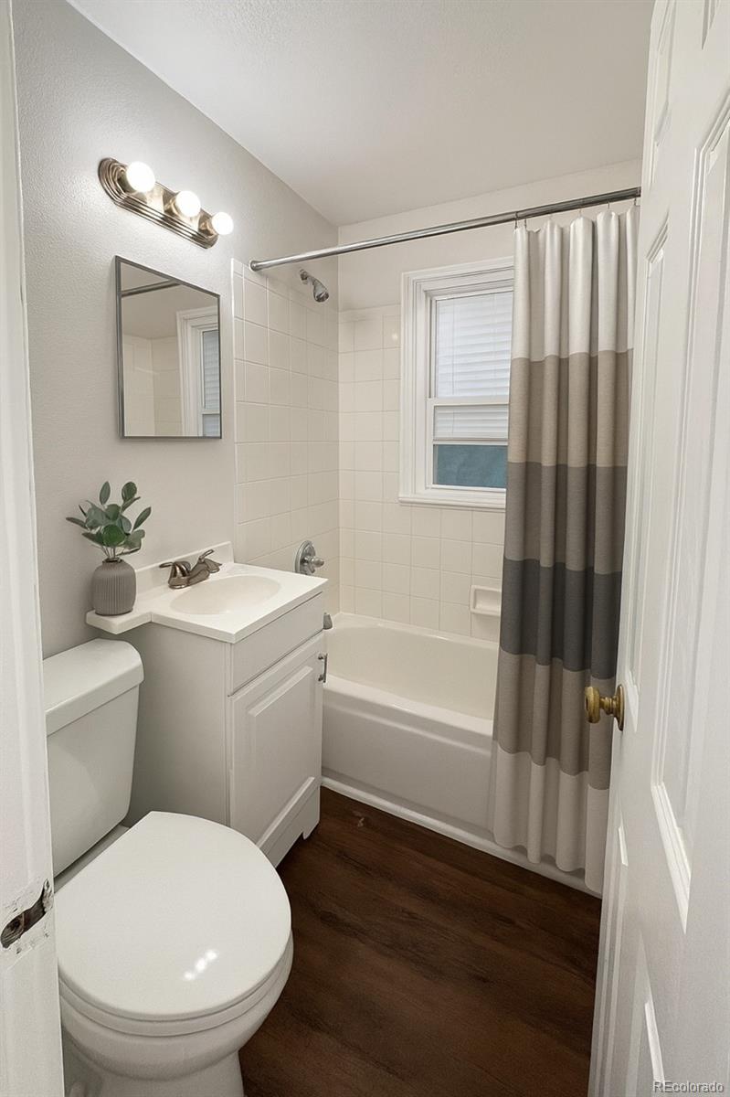 1565 Xanthia Street Denver, CO 80220 - Photo 6 of 7 a bathroom with a toilet a sink and a bathtub