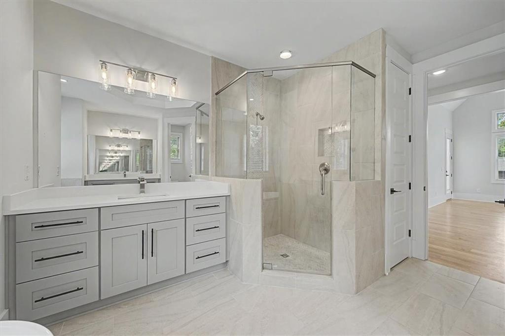 217 Laura Lake Road Marietta, GA 30066 - Photo 37 of 54 a bathroom with a shower sink and mirror
