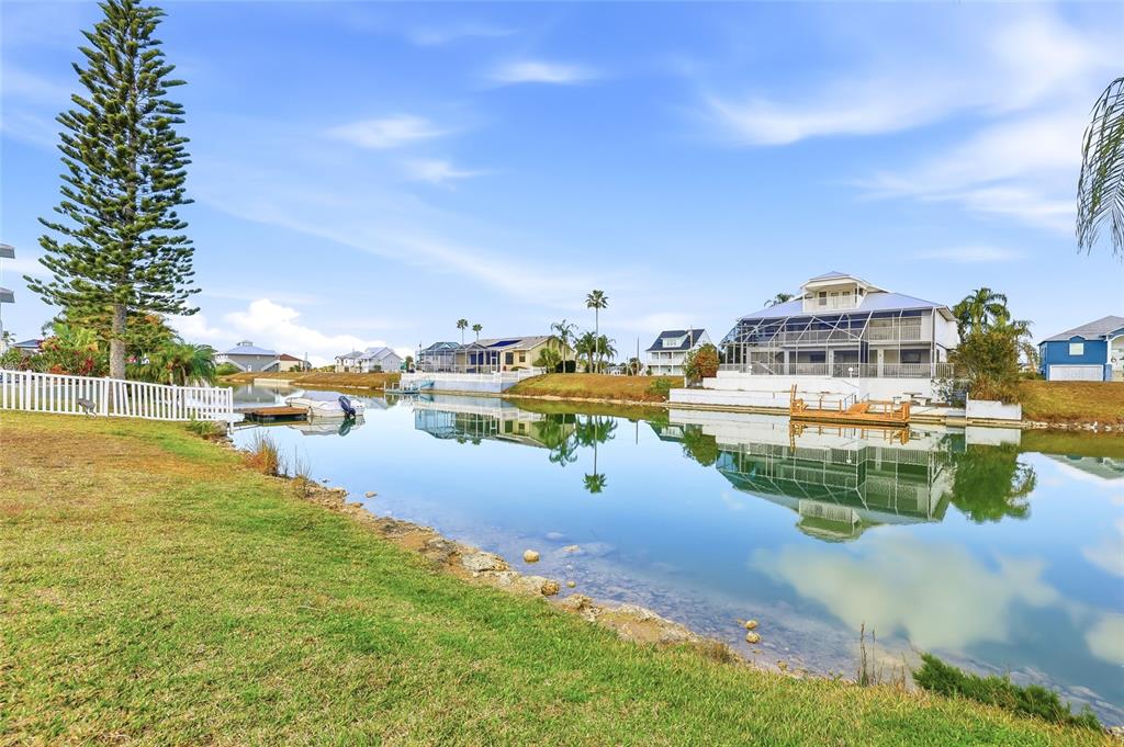 Undisclosed Address Hernando Beach, FL 34607 - Photo 5 of 14 a view of a lake with houses