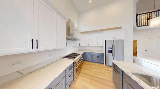 a kitchen with granite countertop a sink stove and refrigerator
