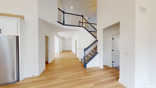 a view of entryway and hall with wooden floor