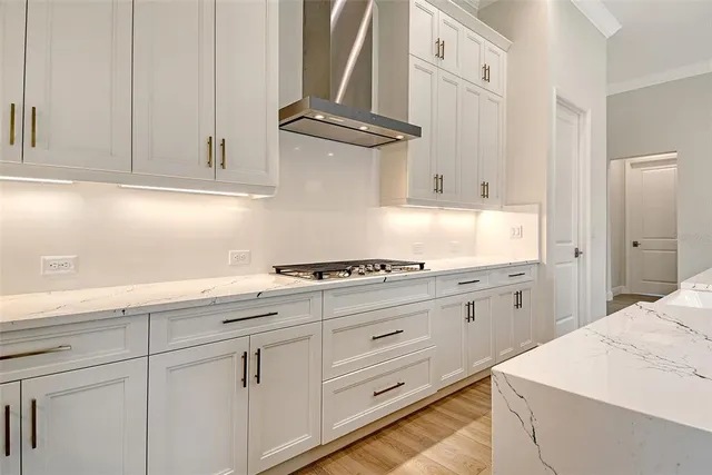 a kitchen with granite countertop white cabinets and white appliances