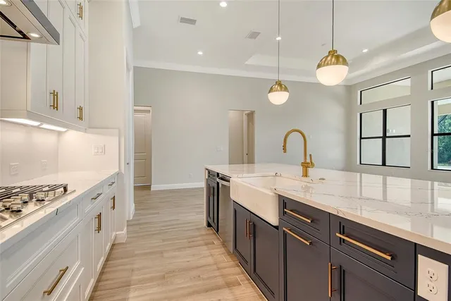 a kitchen with sink stove and cabinets