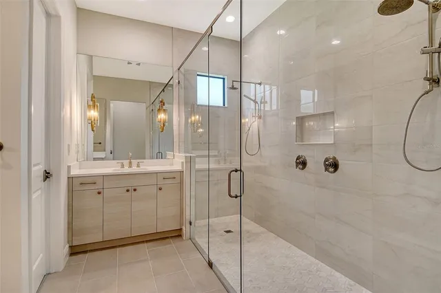 a bathroom with a glass shower door and a sink
