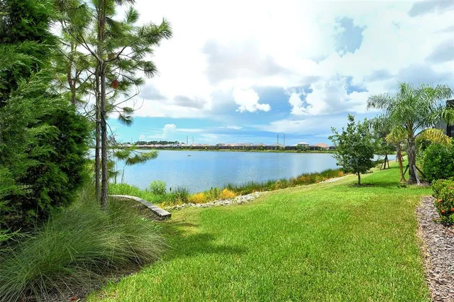 a view of a lake with houses in the back