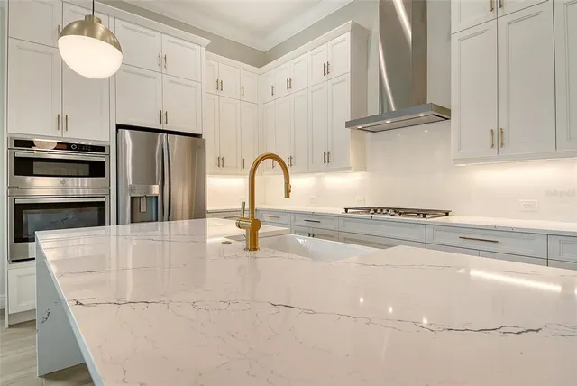 a kitchen with stainless steel appliances a refrigerator and cabinets